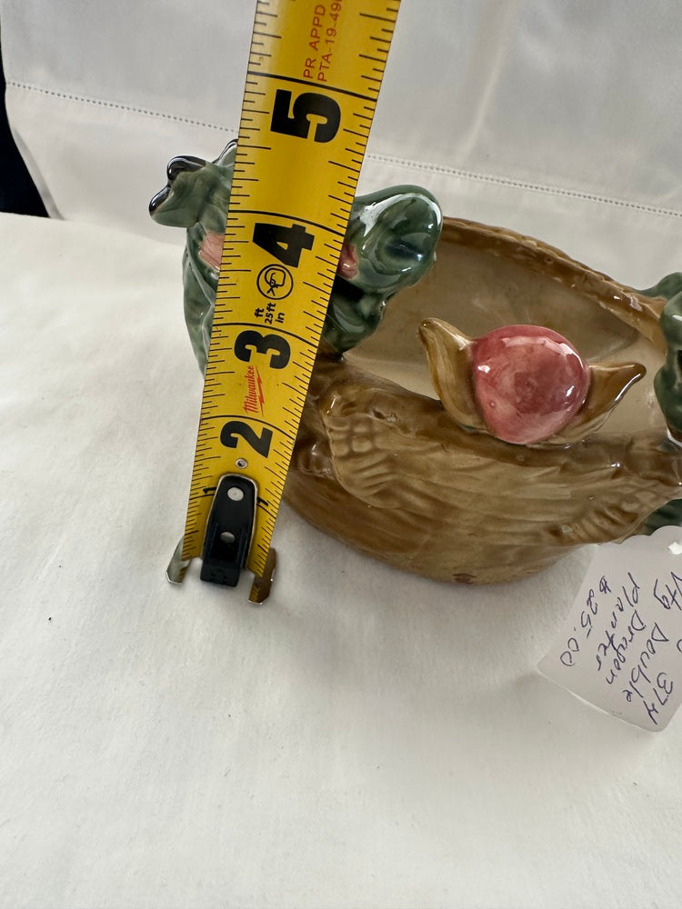Ceramic double dragon planter beside a tape measure showing about 4 inches tall, with price tag