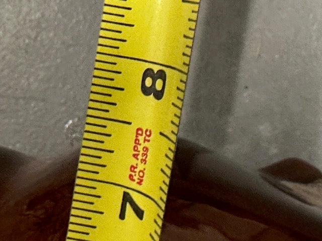 MCM vase rim beside a tape measure indicating roughly 8 inches in height.