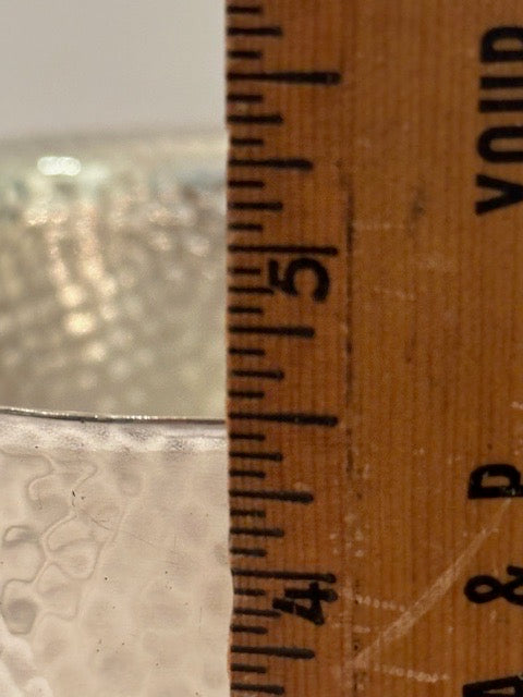 Hammered silver-plate ice bucket; rim measured against a wooden ruler near the five-inch mark