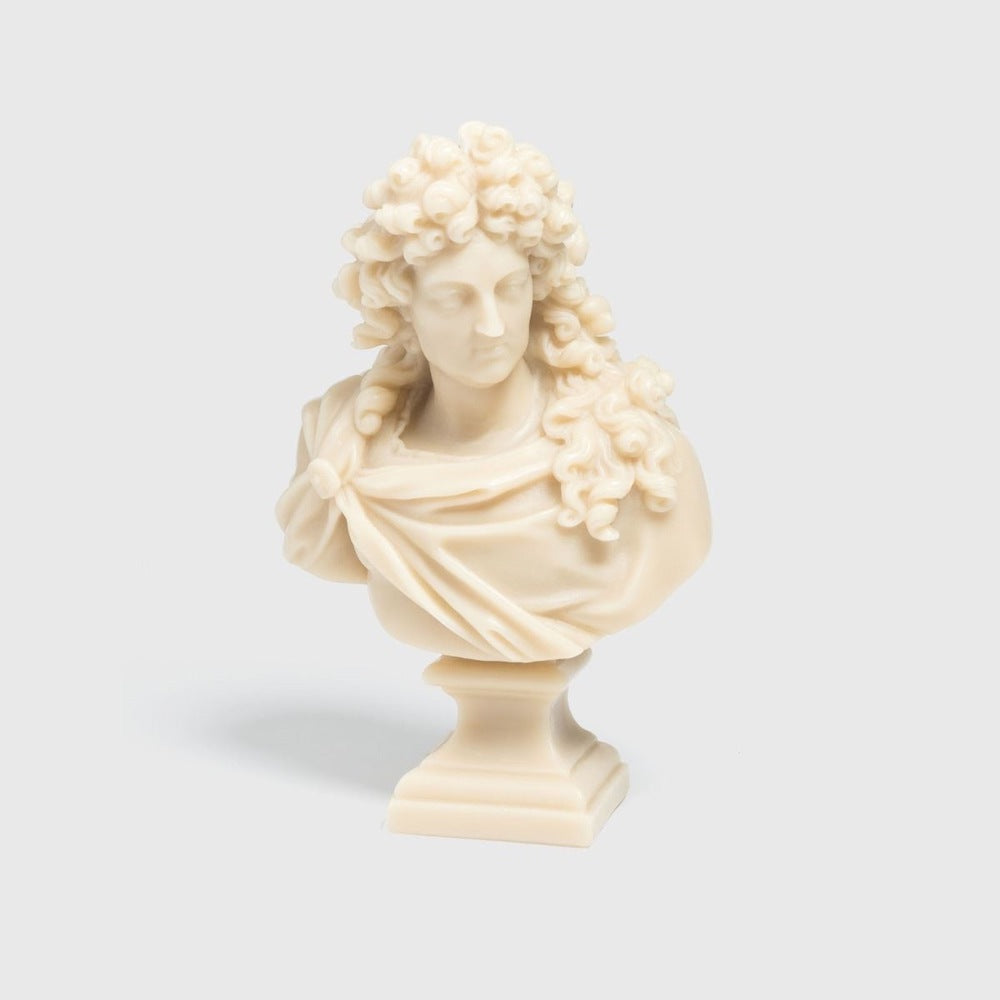 Trudon Louis XIV bust candle in stone-ivory wax with curled wig and draped robe on a square base