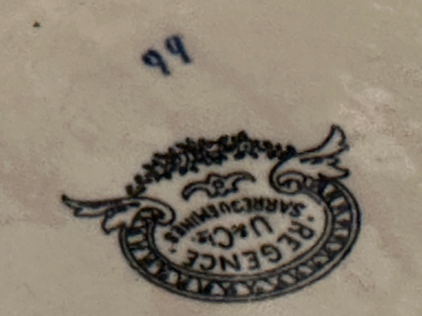 Close-up of the black Regence Sarreguemines backstamp on the bowl's base