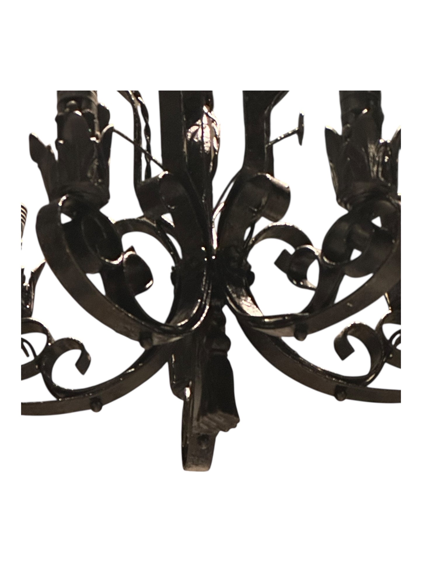 Bottom view of black wrought iron petite chandelier scrollwork and arms