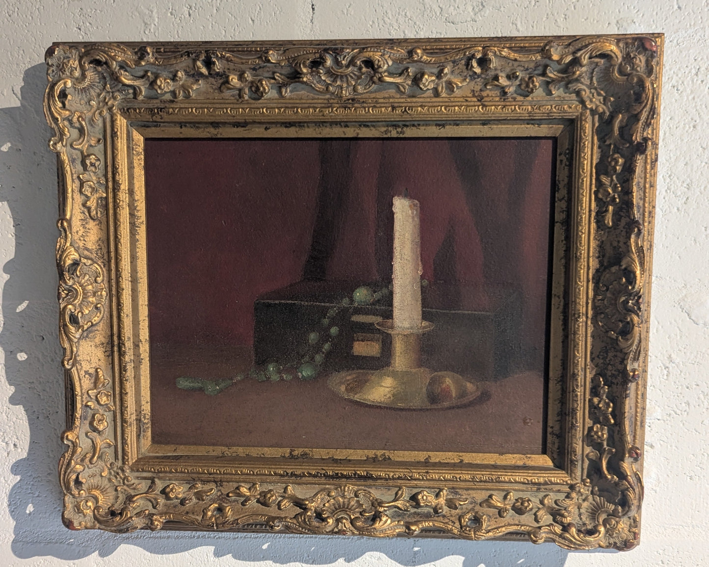 Gilt-framed candlestick and box still life, angled view showing the carved gold frame