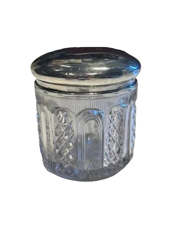 Vintage cut glass and sterling silver vanity jar, angled closed view of the diamond-cut body and domed lid.