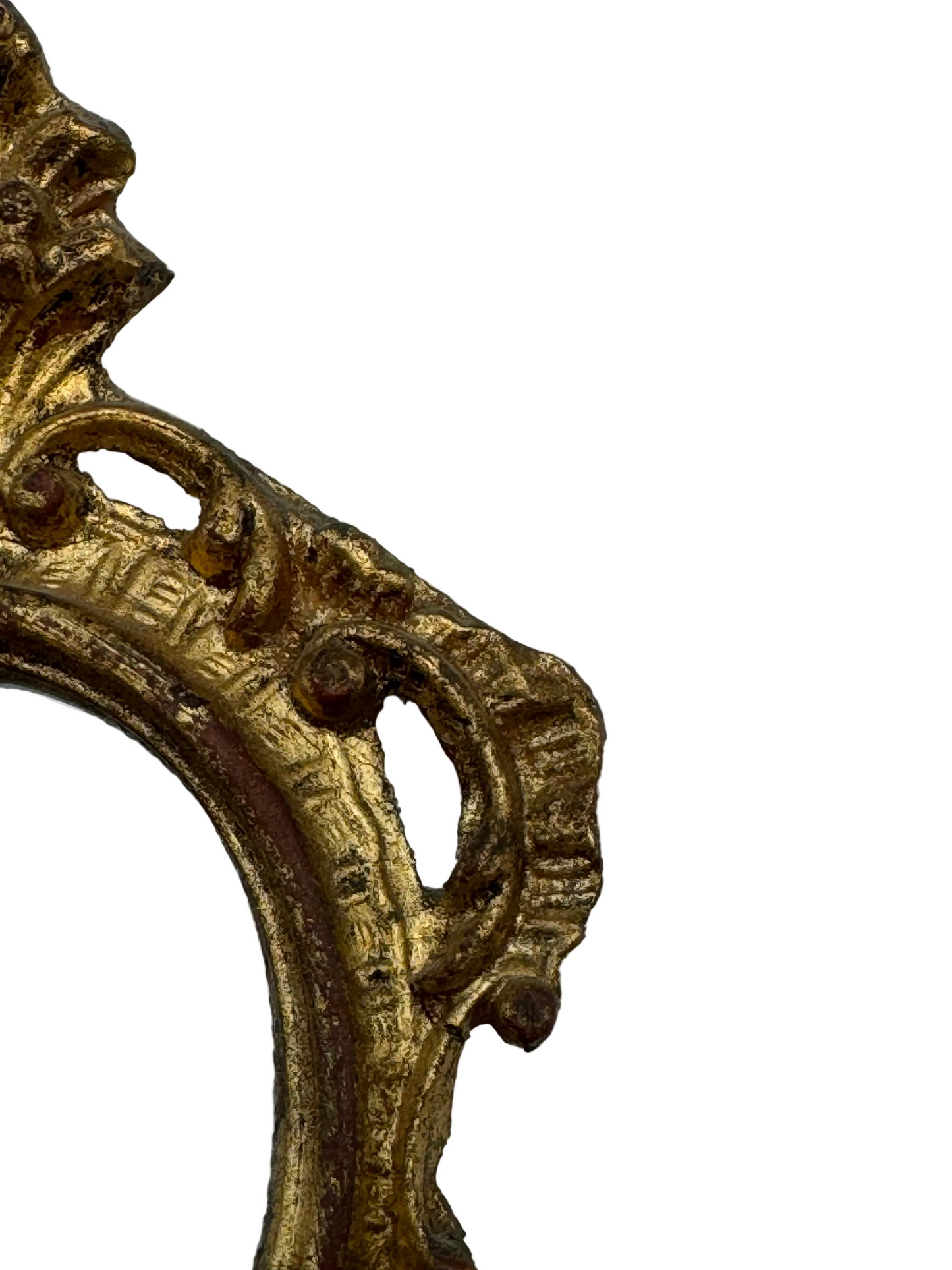 Close-up of the carved gilt scrollwork along the side of the Florentine mirror frame.