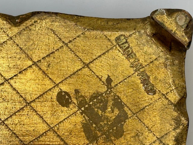 Close-up of Florentine box underside showing faint maker's stamp on gilt base