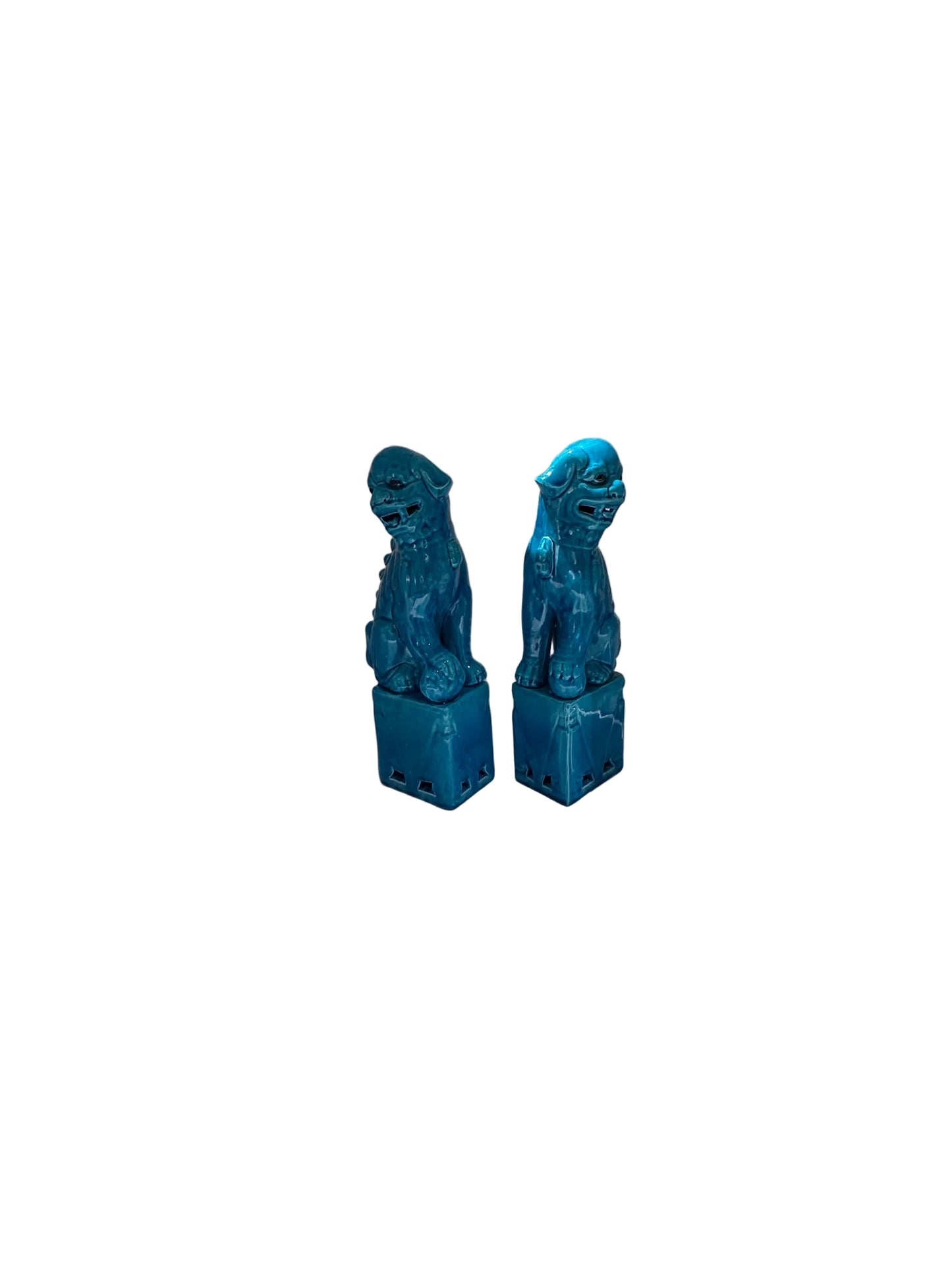 Pair of turquoise glazed ceramic foo dogs, angled three-quarter view on bases