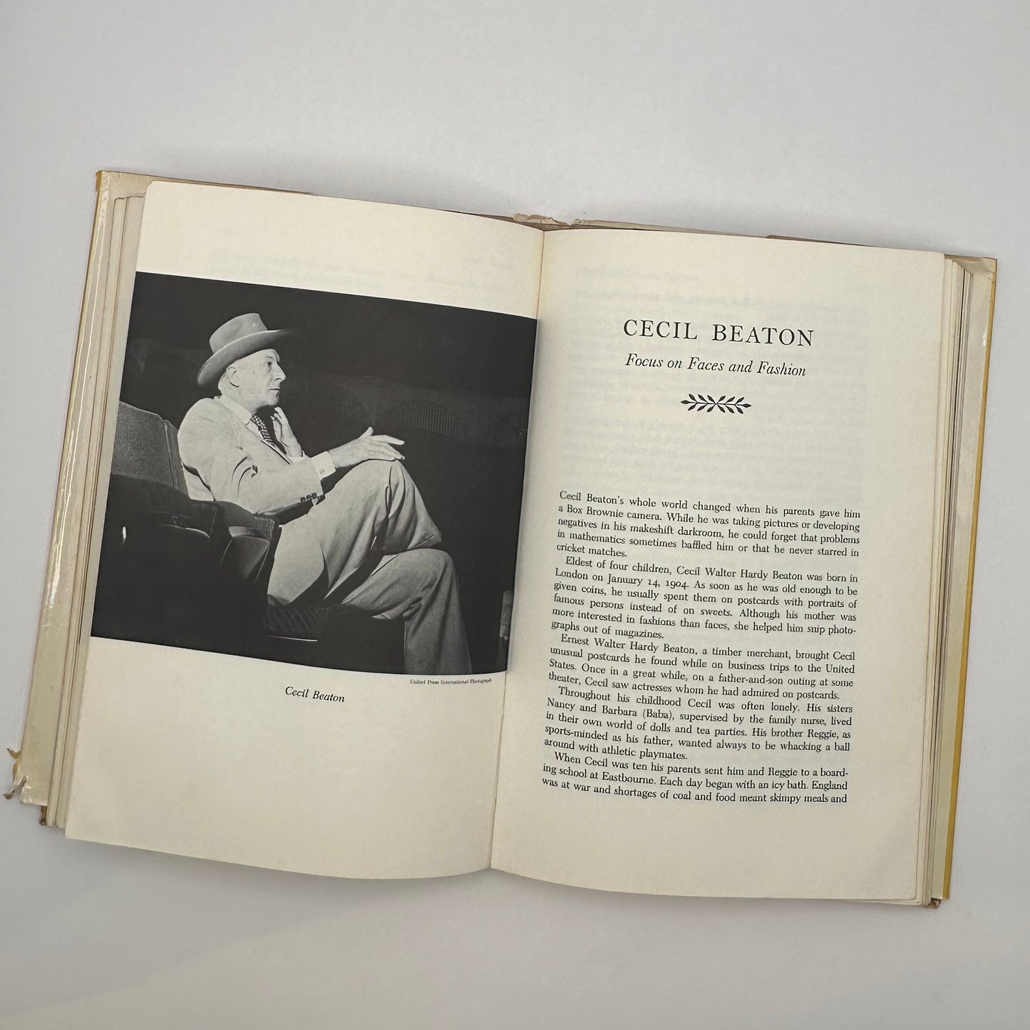 Open book to Cecil Beaton chapter, "Focus on Faces and Fashion," with seated portrait photo