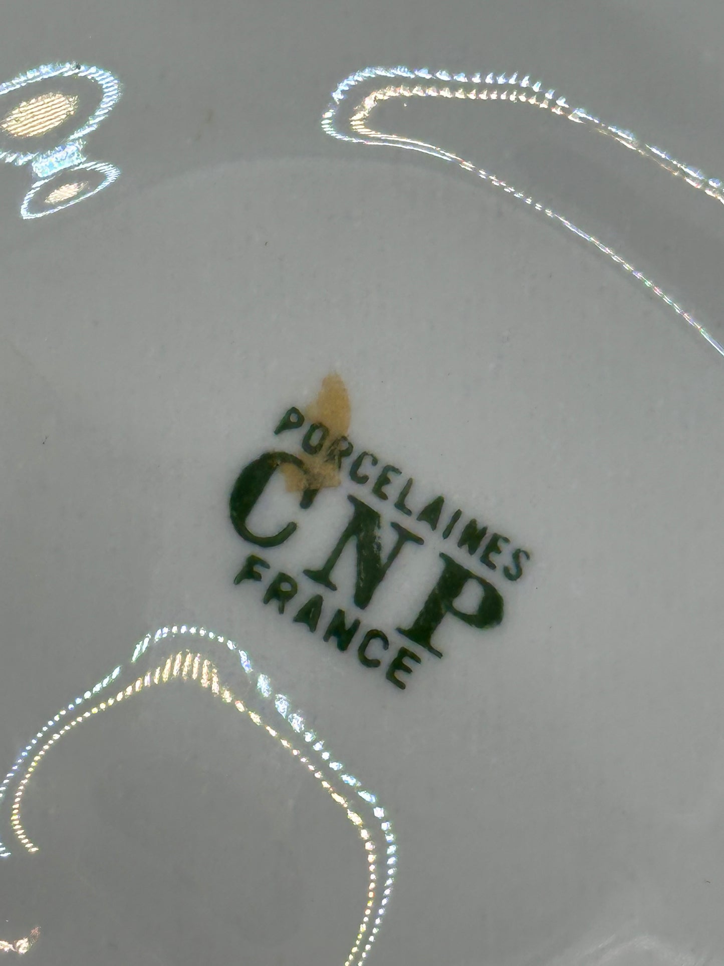 Close-up of maker's mark on oyster dish reading Porcelaines CNP France