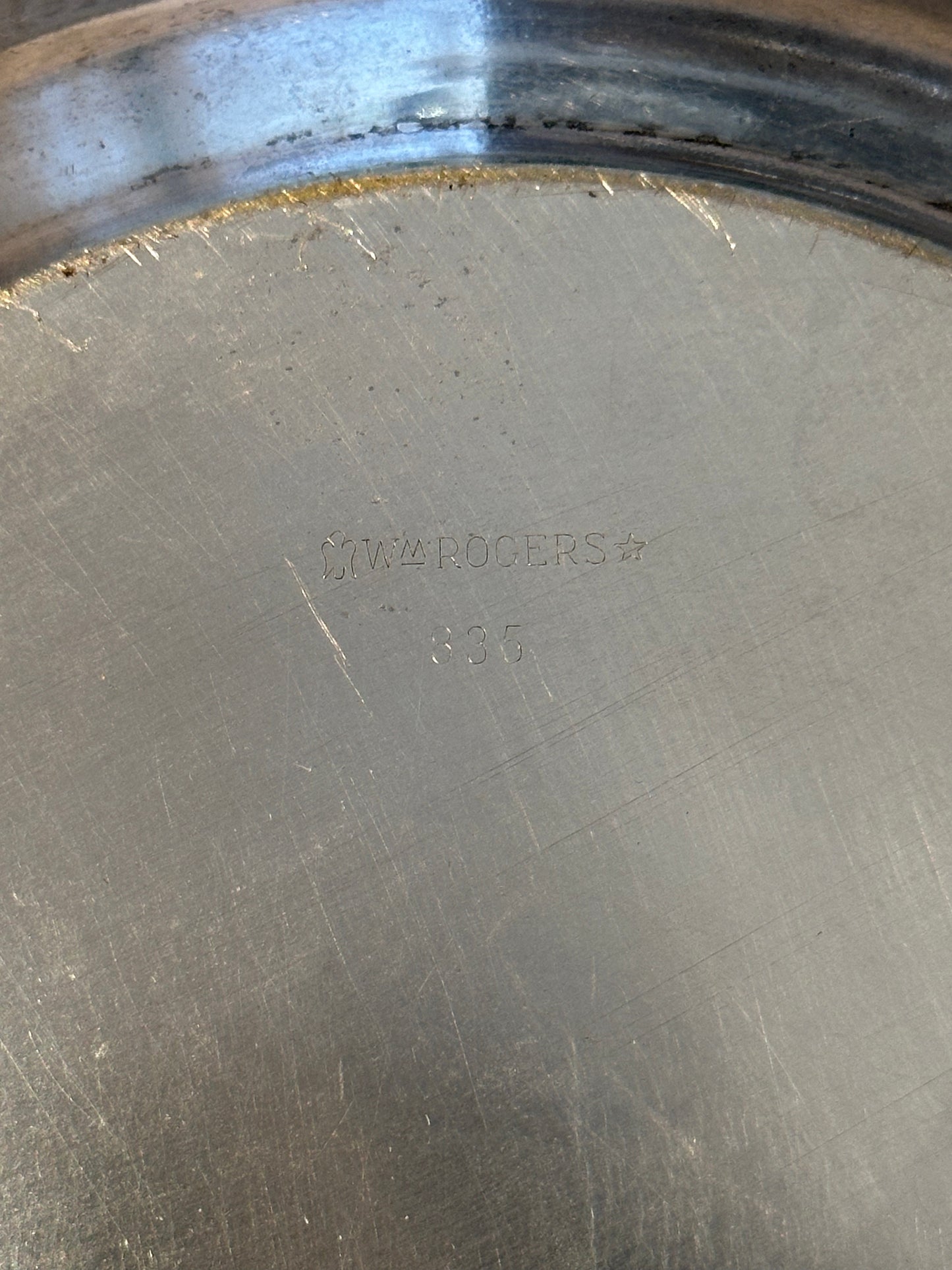 Close-up of 'Wm Rogers 835' maker's mark stamped on bowl underside