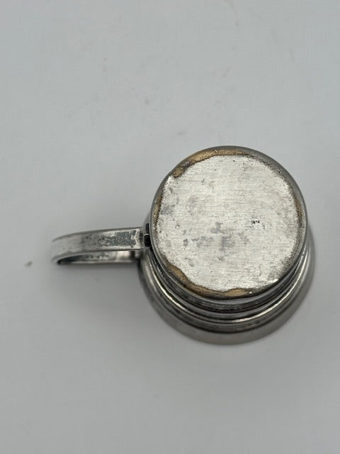 Vintage Art Deco silver-plate jigger, underside view showing the worn base and wire handle