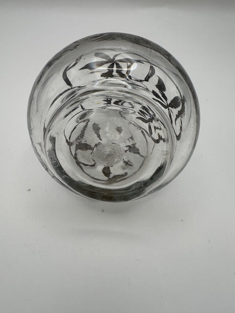 Underside view of clear glass cruet base with silver floral overlay decoration