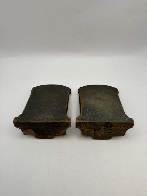 Underside of the bronze Thinker bookends showing aged metal bases