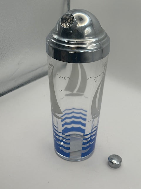 Sailboat cocktail shaker with domed chrome lid open and small cap beside it