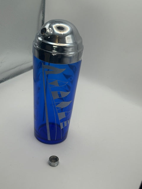 Blue nautical cocktail shaker with chrome lid and separate spout cap beside it