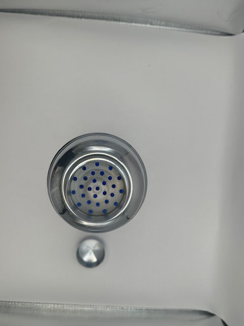 Top view of cocktail shaker's chrome strainer lid