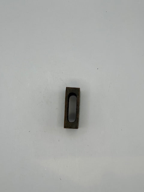 Open brass matchbox-cover frame showing the hollow underside that holds a matchbox