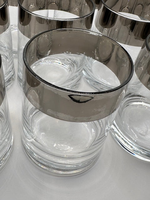 Overhead close-up of MCM silver-banded glass rims, Dorothy Thorpe style