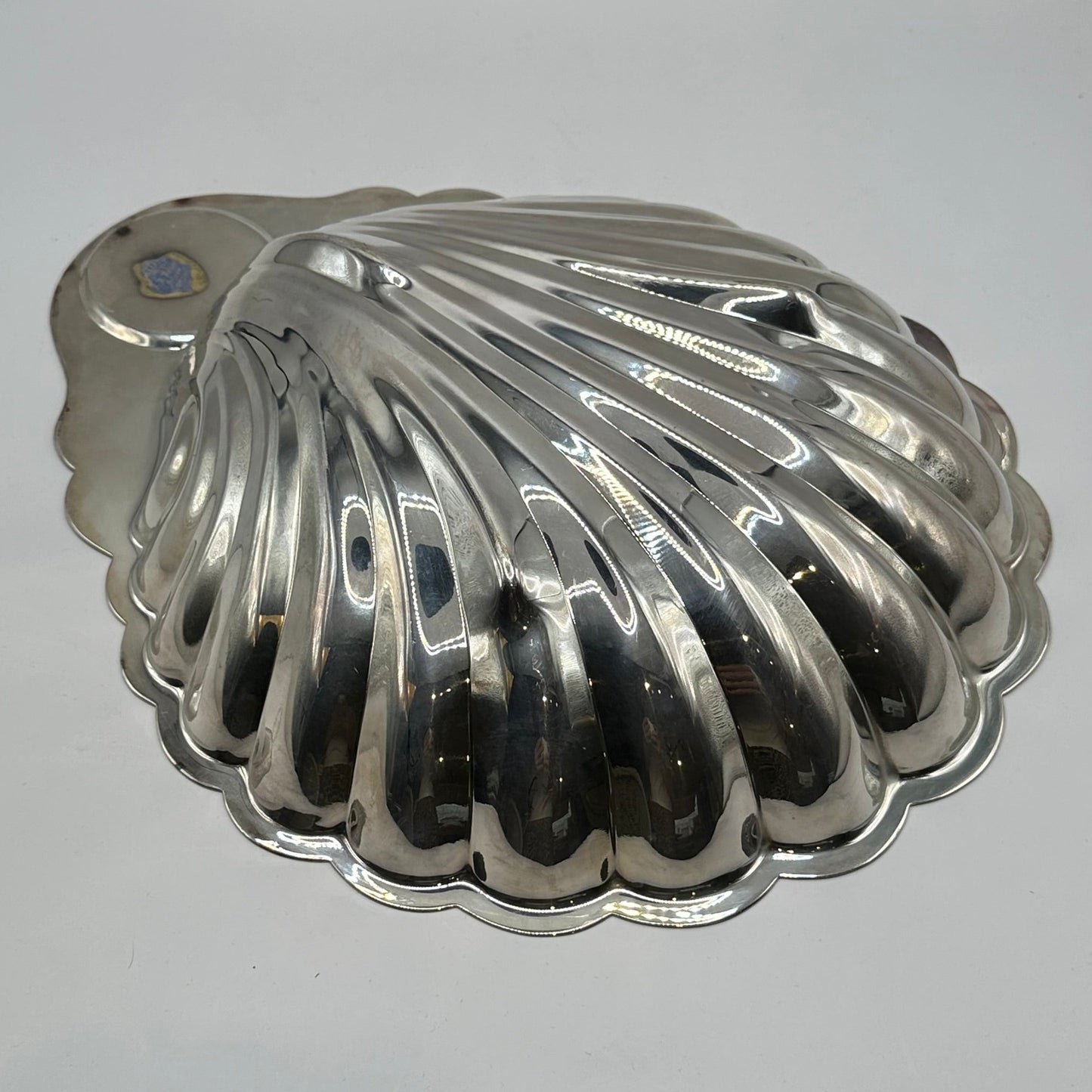 Underside of the Rogers silver plate shell server, ribbed scallop exterior with small label remnant