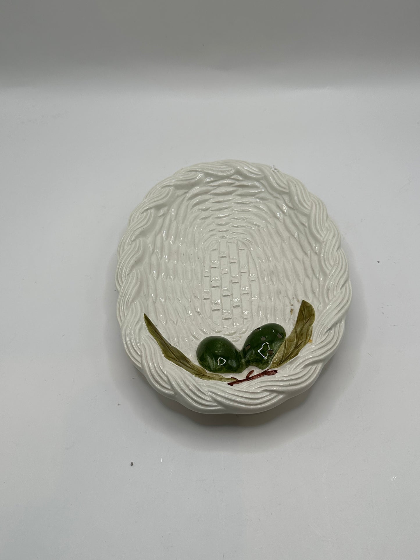 Italian ceramic olive dish, top view of basketweave well and green olive-and-leaf relief