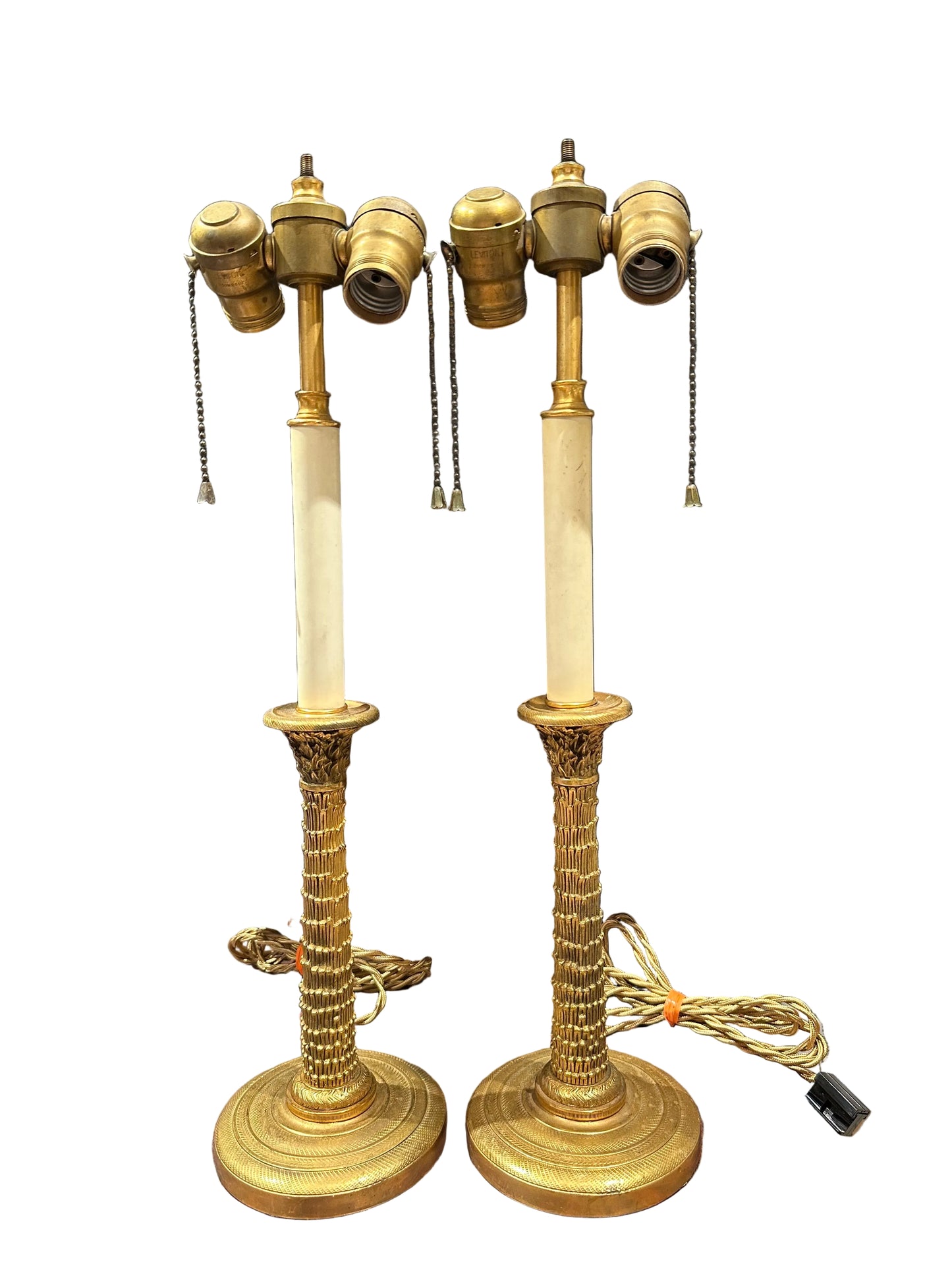 Pair of gilt bronze candlestick lamps, close view of twin brass sockets and reeded gilt bases