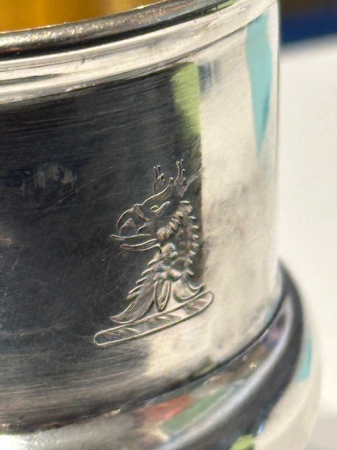 Detail of small engraved crest on the outside of the silver plate toothpick holder