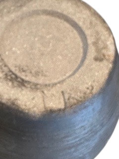 Close-up of the pinched vase's unglazed sandy foot ring, base view