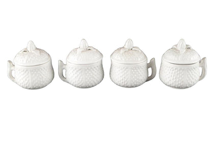 Set of four Mottahedeh white strawberry ceramic pots de creme with lids, lined up