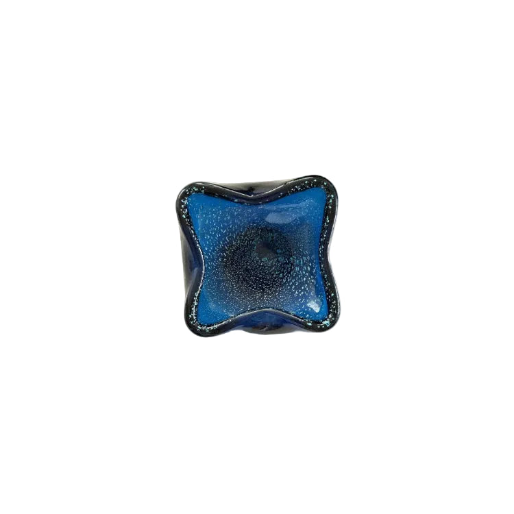 Overhead angled view of the blue Murano bullicante dish interior and bubbles.