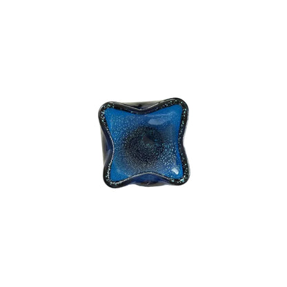 Overhead angled view of the blue Murano bullicante dish interior and bubbles.