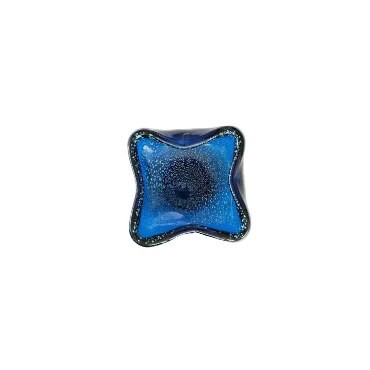 Top-down view of the blue Murano dish, controlled bubbles spiraling from the center.