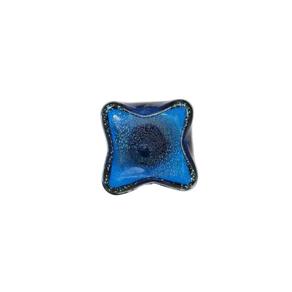 Top-down view of the blue Murano dish, controlled bubbles spiraling from the center.