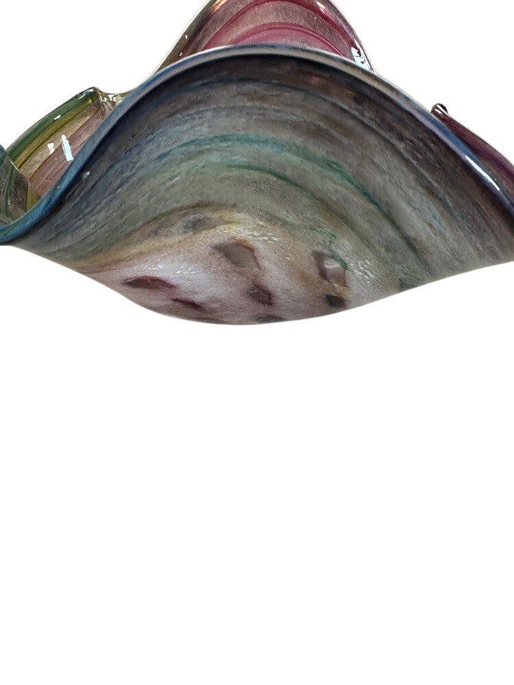 Close-up of the curved rim and underside of the Murano style rainbow handblown glass bowl