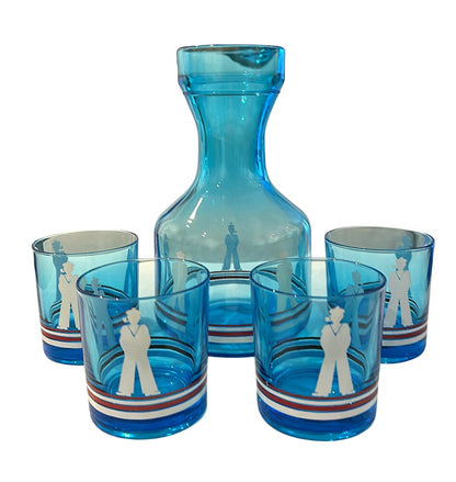 MCM blue glass sailor-motif carafe with four matching tumblers, each with red, white and blue striped bases.