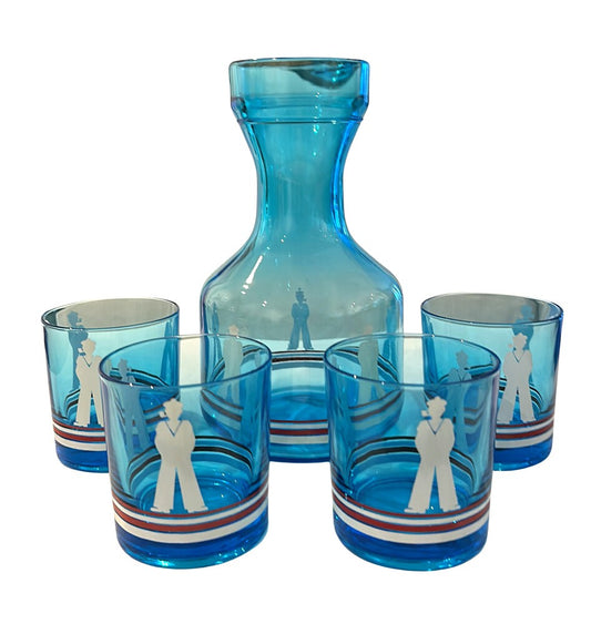 MCM blue glass sailor-motif carafe with four matching tumblers, each with red, white and blue striped bases.
