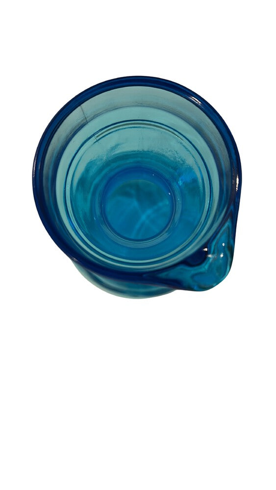 Angled top view of the blue glass carafe opening and pour spout.