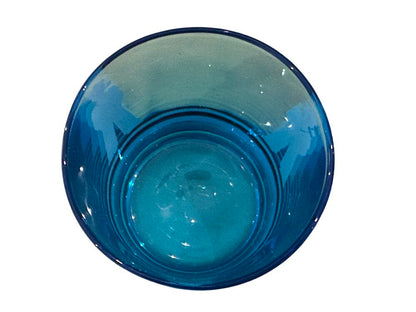 Looking down into a single blue glass, sailor figures visible through the tinted walls.