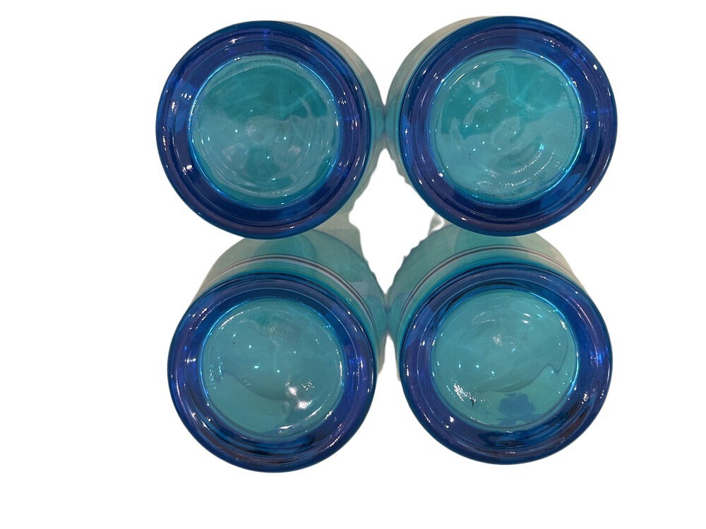 Close-up of the bases of four blue sailor glasses turned upside down.