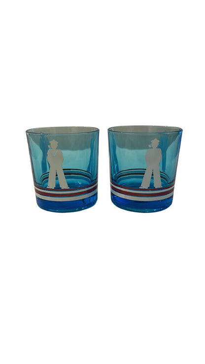 Two blue sailor-motif rocks glasses, front view showing white sailor silhouette and striped bands.