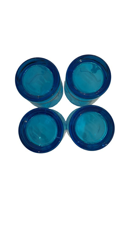 Overhead view of four blue sailor glasses arranged in two rows, showing their bases.