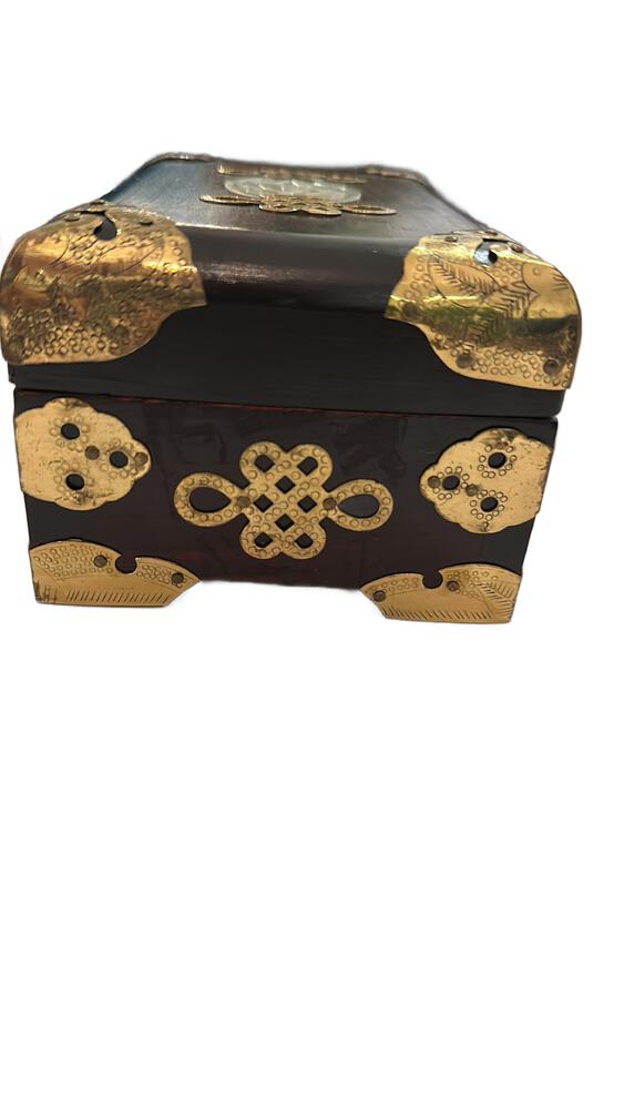 Three-quarter view of the Asian wood box with brass knot mount and corner fittings