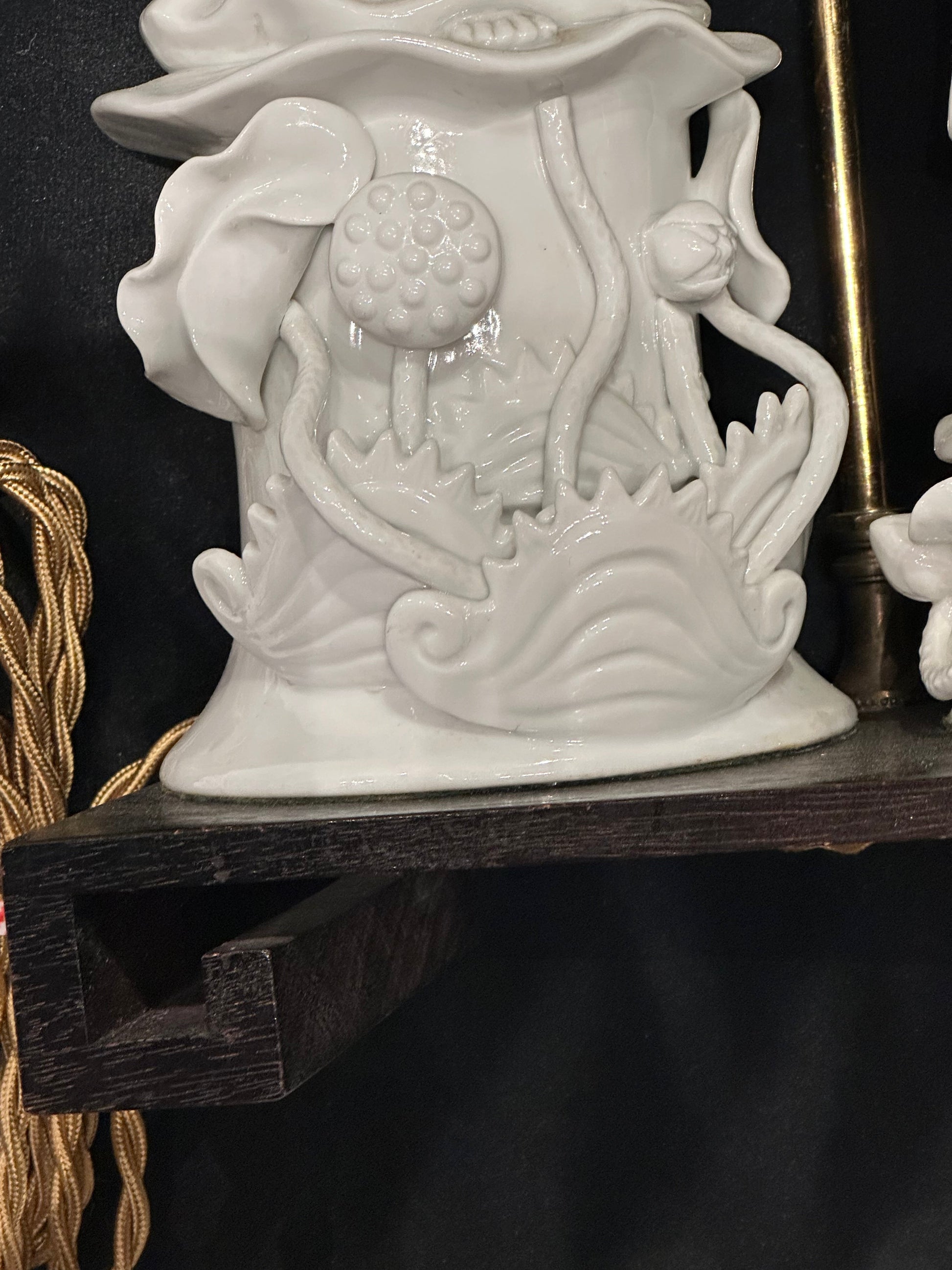 Close-up of the porcelain lotus and foliage base detail on the blanc de Chine table lamp