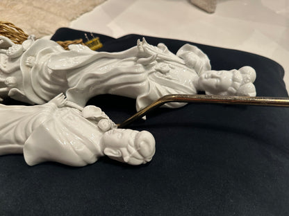 Detail of the two reclining blanc de Chine porcelain figures showing serene sculpted faces