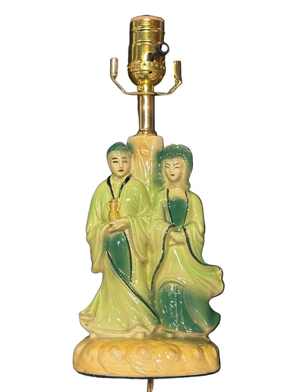 Front view of the chinoiserie double-figure pottery lamp in green and cream glaze
