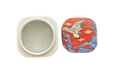 Vintage porcelain small box, open: white interior base beside red lid with a white flying crane.
