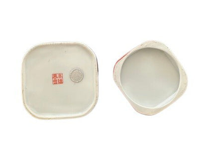 Vintage porcelain small box underside: red maker's seal mark on lid base and white interior of box.