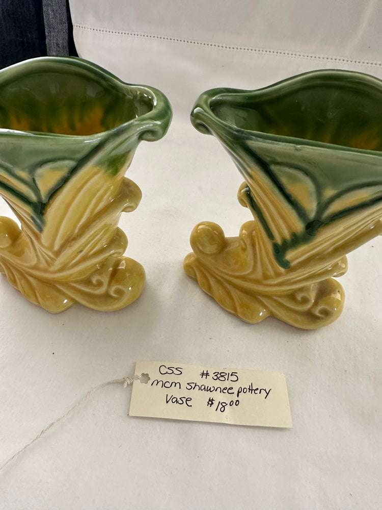 Vintage Shawnee Pottery vases standing with a handwritten tag reading 'MCM Shawnee Pottery Vase'