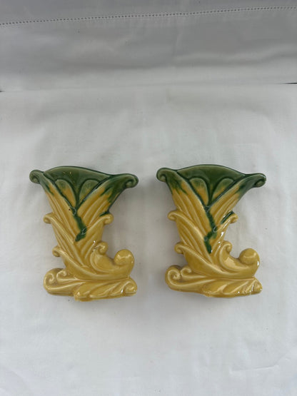 Pair of vintage Shawnee Pottery cornucopia vases standing upright on white cloth, front view