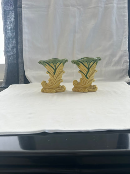 Pair of vintage Shawnee Pottery cornucopia vases on white cloth near a window, styled view