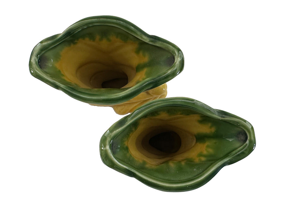 Two vintage Shawnee Pottery vases from above, green-rimmed flared openings revealing yellow interiors